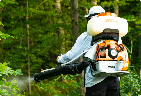 Close view of man spraying for mosquitos 